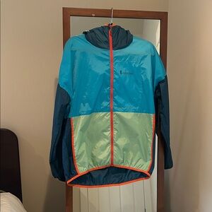 Cotopaxi Blue and Green Raincoat with Orange Trim